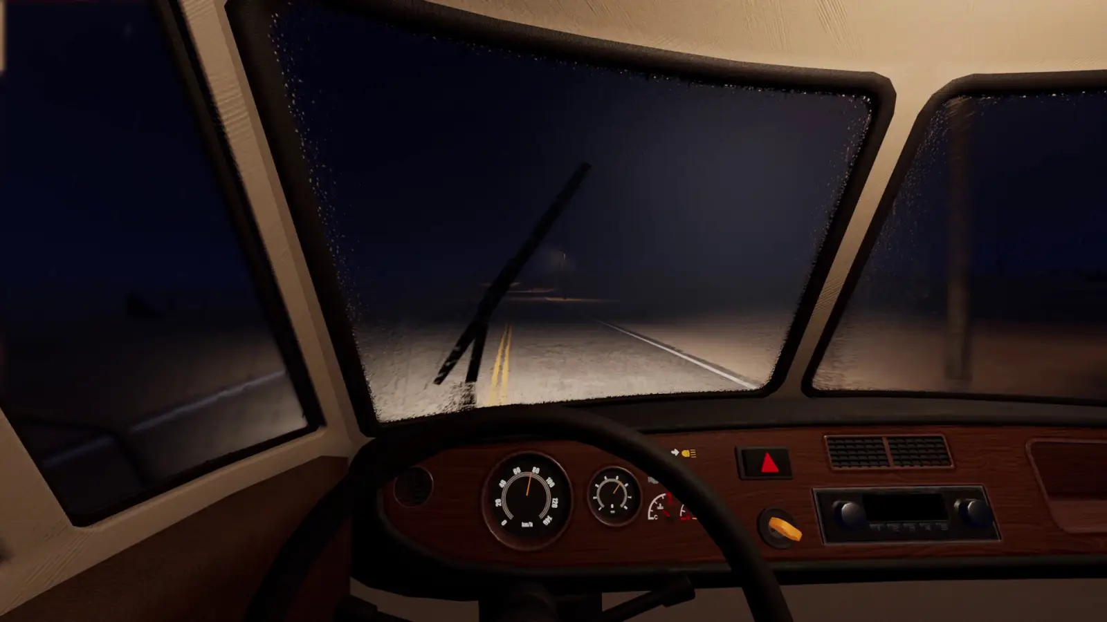 Night rain on the Nomad Drive RV windshield, wipers and dashboard visible