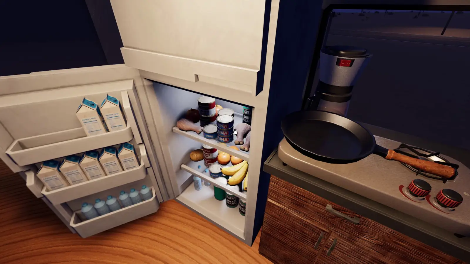 Open fridge and a pan on the stove inside a Nomad Drive RV